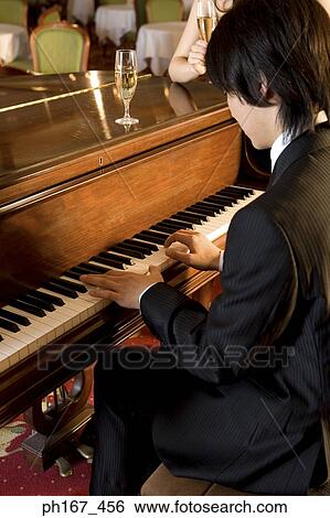 Stock Photograph - Man playing piano. Fotosearch