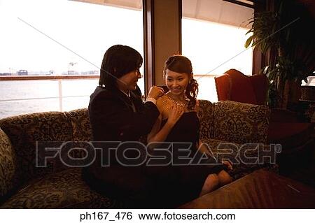 Man putting on necklace for woman View Large Photo Image Stock Photograph - Man putting on necklace for woman. Fotosearch
