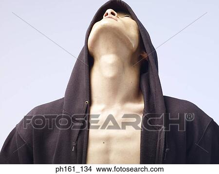 Man wearing a hooded jacket, looking up View Large Photo Image Picture - Man wearing a hooded jacket, looking up. Fotosearch