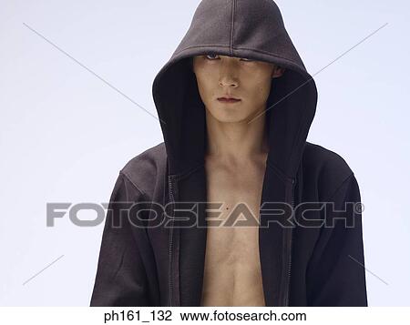 Man wearing a hooded jacket View Large Photo Image Stock Image - Man wearing a hooded jacket. Fotosearch