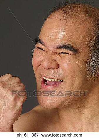 Mature man laughing with fist in the air View Large Photo Image Stock Photo - Mature man laughing with fist in the air. Fotosearch