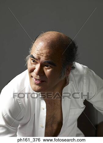 Mature man wearing a white shirt, unbuttoned View Large Photo Image Stock Photograph - Mature man wearing a white shirt, unbuttoned. Fotosearch