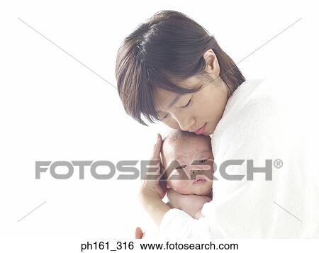 Mother holding her baby close to her View Large Photo Image Stock Photograph - Mother holding her baby close to her. Fotosearch