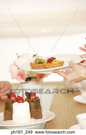 Plates of desserts being passed around View Large Photo Image Stock Photo - Plates of desserts being passed around. Fotosearch