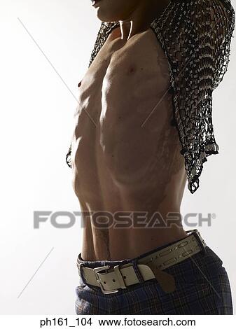 Picture - Portrait of a man wearing a netted top, stretching. Fotosearch