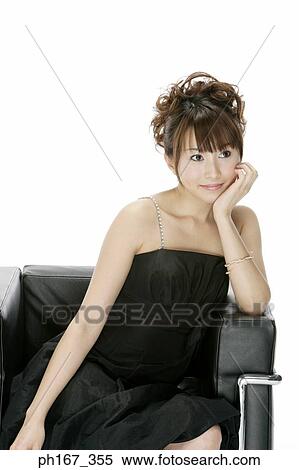 Portrait of a woman sitting on a sofa, close-up View Large Photo Image Stock Photography - Portrait of a woman sitting on a sofa, close-up. Fotosearch