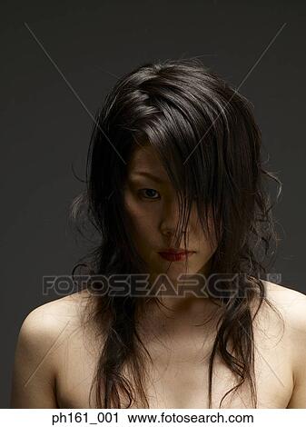Stock Image - Portrait of a young woman with long hair. Fotosearch
