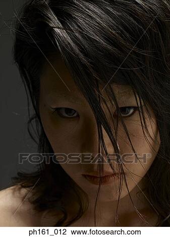 Stock Image - Portrait of a young woman with long hair. Fotosearch