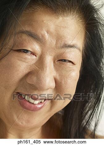 Portrait of mature woman, smiling, close-up View Large Photo Image Stock Photography - Portrait of mature woman, smiling, close-up. Fotosearch