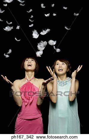 Portrait of two women playing with feathers View Large Photo Image Stock Image - Portrait of two women playing with feathers. Fotosearch