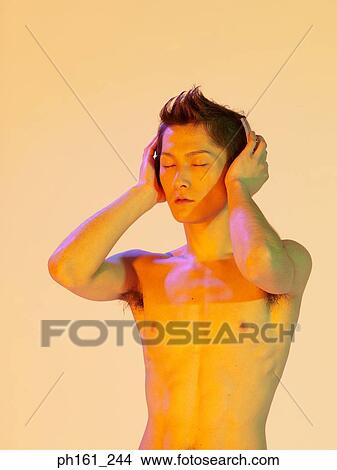 Picture - Shirtless man holding his hands to his ears. Fotosearch