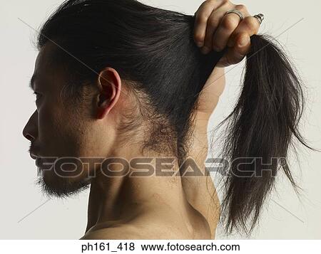 Shirtless young man holding his long hair up, side view View Large Photo Image Stock Photo - Shirtless young man holding his long hair up, side view. Fotosearch