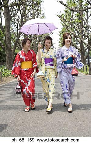 Three women taking a stroll down the park View Large Photo Image Stock Photo - Three women taking a stroll down the park. Fotosearch