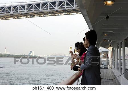 Two couple enjoying the view onboard a cruise ship View Large Photo Image Stock Image - Two couple enjoying the view onboard a cruise ship. Fotosearch