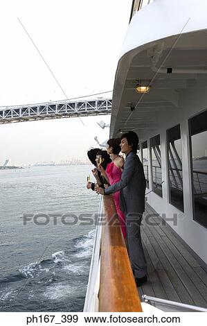 Stock Photo - Two couple enjoying the view onboard a cruise ship. Fotosearch