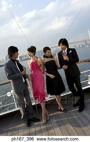 Stock Photograph - Two couple having champagne onboard a cruise ship. Fotosearch