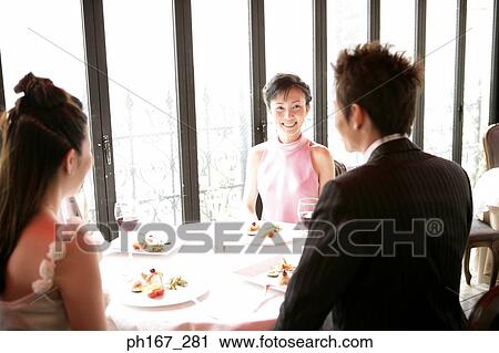 Two couples dining in a restaurant View Large Photo Image Stock Image - Two couples dining in a restaurant. Fotosearch