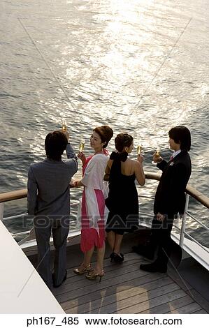 Two couples enjoying the sunset onboard a cruise ship, high angle view View Large Photo Image Stock Photography - Two couples enjoying the sunset onboard a cruise ship, high angle view. Fotosearch