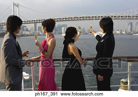 Stock Image - Two couples enjoying the view onboard a cruise ship. Fotosearch