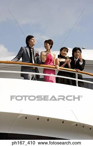 Stock Image - Two couples enjoying the view onboard a cruise ship. Fotosearch