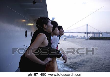 Stock Image - Two couples enjoying the view onboard a cruise ship. Fotosearch