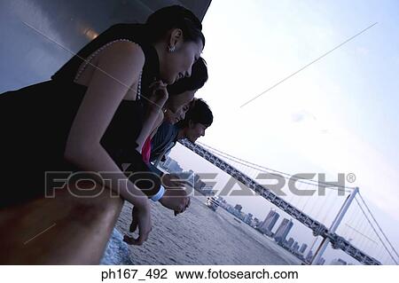 Stock Image - Two couples enjoying the view onboard a cruise ship. Fotosearch