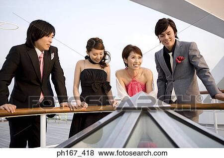 Two couples enjoying the view onboard a cruise ship View Large Photo Image Stock Photo - Two couples enjoying the view onboard a cruise ship. Fotosearch