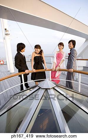Two couples enjoying the view onboard a cruise ship View Large Photo Image Stock Photo - Two couples enjoying the view onboard a cruise ship. Fotosearch