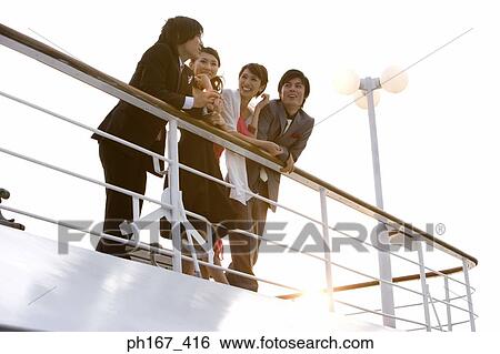 Two couples enjoying the view onboard a cruise ship View Large Photo Image Stock Photograph - Two couples enjoying the view onboard a cruise ship. Fotosearch