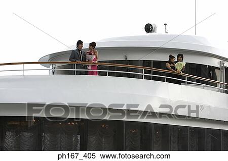 Two couples enjoying the view onboard a cruise ship View Large Photo Image Stock Photography - Two couples enjoying the view onboard a cruise ship. Fotosearch
