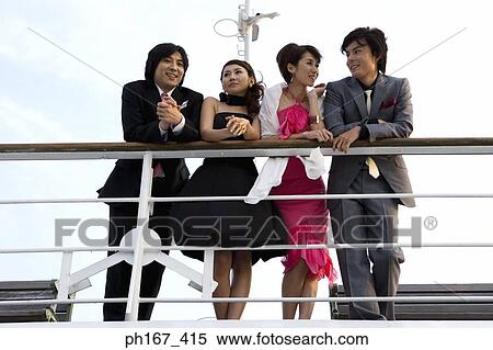 Stock Photography - Two couples enjoying the view onboard a cruise ship. Fotosearch