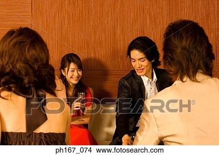 Picture - Two couples having champagne. Fotosearch