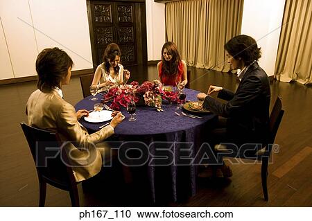 Two couples having dinner View Large Photo Image Stock Image - Two couples having dinner. Fotosearch