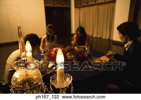 Stock Image - Two couples having dinner. Fotosearch