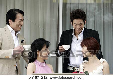 Two couples having tea, outdoor, close-up View Large Photo Image Stock Image - Two couples having tea, outdoor, close-up. Fotosearch
