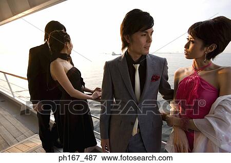 Stock Photo - Two couples onboard a cruise ship. Fotosearch