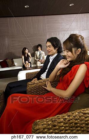Two couples relaxing in a house View Large Photo Image Stock Photo - Two couples relaxing in a house. Fotosearch