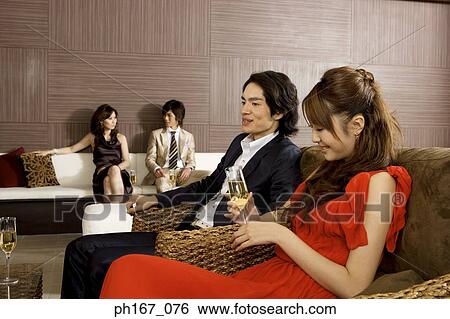 Two couples relaxing in a house View Large Photo Image Stock Photograph - Two couples relaxing in a house. Fotosearch
