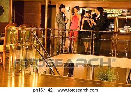 Two couples relaxing in bar of cruise ship View Large Photo Image Stock Image - Two couples relaxing in bar of cruise ship. Fotosearch
