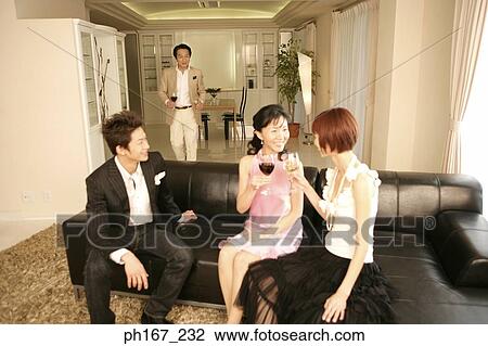 Two couples relaxing over wine View Large Photo Image Stock Image - Two couples relaxing over wine. Fotosearch