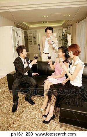 Two couples relaxing over wine View Large Photo Image Stock Image - Two couples relaxing over wine. Fotosearch