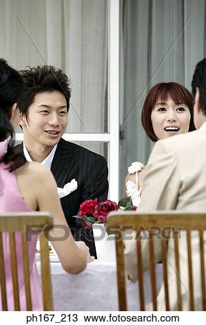 Two couples sitting at dining table, outdoor View Large Photo Image Stock Image - Two couples sitting at dining table, outdoor. Fotosearch