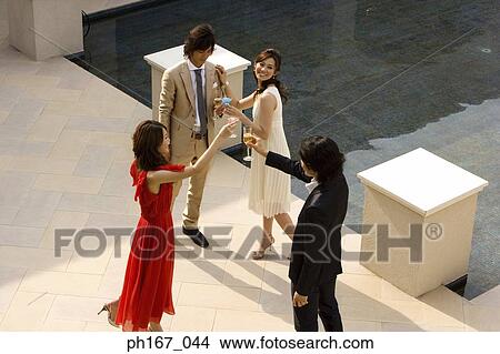 Two couples toasting, high angle View Large Photo Image Picture - Two couples toasting, high angle. Fotosearch