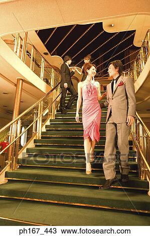 Two couples walking down steps of cruise ship View Large Photo Image Stock Image - Two couples walking down steps of cruise ship. Fotosearch