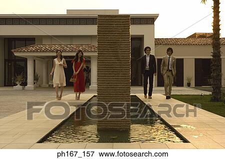 Stock Photo - Two couples walking in the courtyard. Fotosearch