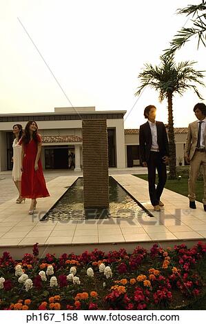 Stock Photo - Two couples walking in the courtyard. Fotosearch