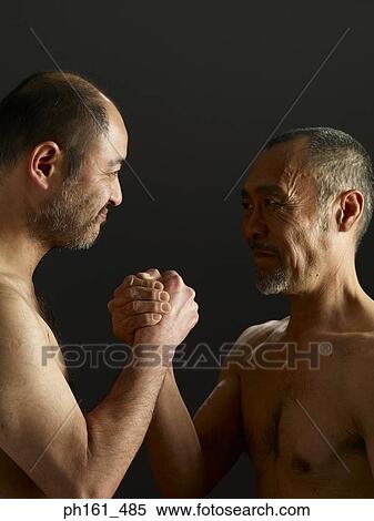 Two mature men clasping hands View Large Photo Image Stock Photography - Two mature men clasping hands. Fotosearch