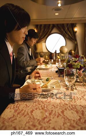 Stock Photo - Two men enjoying a meal. Fotosearch