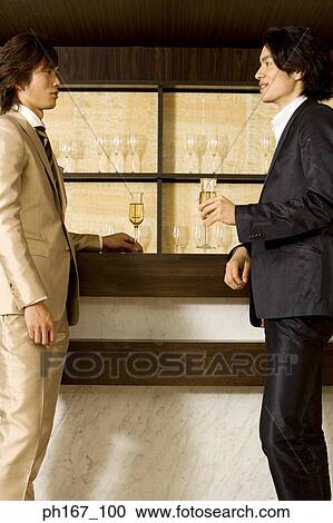 Two men relaxing by the bar View Large Photo Image Stock Image - Two men relaxing by the bar. Fotosearch