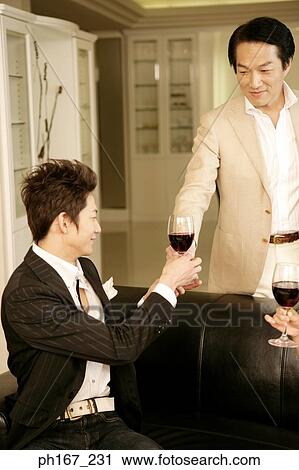 Two men relaxing over wine View Large Photo Image Stock Image - Two men relaxing over wine. Fotosearch